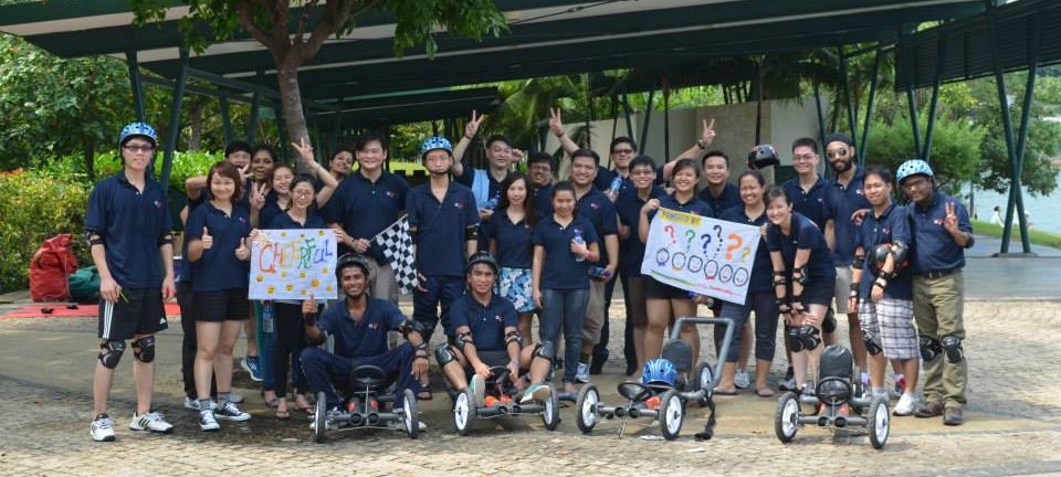 Our Company staff riding a bike in a group photo