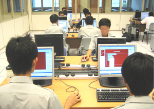 Close up shot of Secondary school children using laptops in the computer lab.